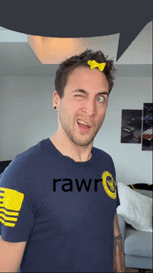 a man wearing a blue shirt with rawr on it