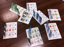 a table topped with a bunch of cards with trees on them