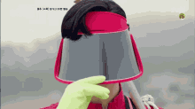 a person wearing a pink visor with a tvn logo on it