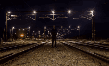 a man kneeling on a train track with a mask on his face that says ' n ' on it