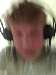 a blurry photo of a man wearing headphones