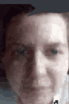 a pixelated image of a man 's face with a black arrow pointing to his left