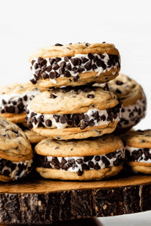 a stack of chocolate chip cookie sandwiches on a wooden stump