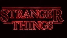 a neon sign that says `` stranger things '' is glowing in the dark .