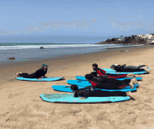 three people holding surfboards on a beach one of which has a sticker on it that says ' ep ' on it