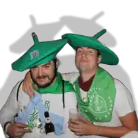 two men wearing green hats and a green scarf that says burgos on it