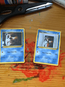 a pair of harry potter cards on a wooden surface