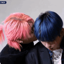 a man with pink hair is kissing a man with blue hair .