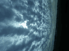 the sun is shining through the clouds in a dark sky