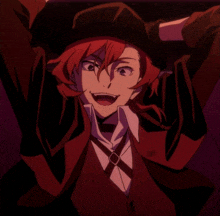 a man with red hair and a black hat is smiling