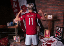 a man in a red shirt with the number 11 on the back