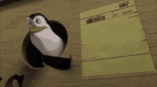 a penguin is sticking its head out of a hole next to a piece of paper that says 60547