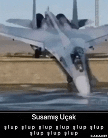 a fighter jet is sitting in the water with the words susamis ucak written on the bottom