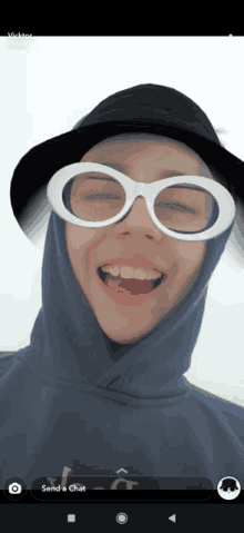 a person wearing a hat and glasses with the words send a chat on the bottom right