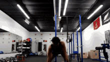 a man is doing push ups in a gym with a flag that says ' new zealand ' on it