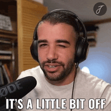 a man wearing headphones with the words " it 's a little bit off " below him