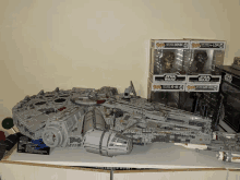 a collection of star wars toys including a millennium falcon toy