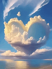 a cloud in the shape of a heart is floating over the ocean