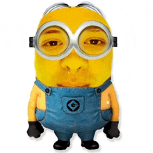 a yellow minion wearing overalls and goggles with the letter g on his chest