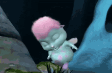 a cartoon fairy with pink hair is sleeping in the dark .