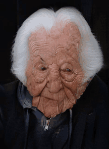 a close up of an elderly woman 's face with wrinkles