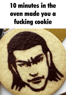 a cookie with a man 's face drawn on it