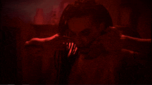 a man with dreadlocks is wearing earrings in a dark room