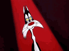 a black and white cartoon cat with blue eyes is standing in front of a red light .