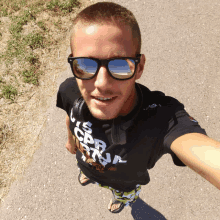 a man wearing sunglasses and a t-shirt that says ' i 'm a cbn ' on it