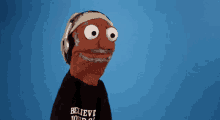 a cartoon puppet wearing headphones and a t-shirt that says believe your own