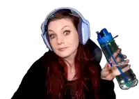 a woman wearing headphones is holding a bottle of water