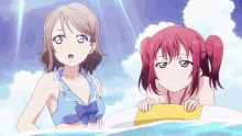 two anime girls are standing next to each other in the water .