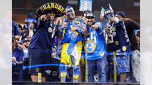 a group of people wearing chargers jerseys are standing in a stadium