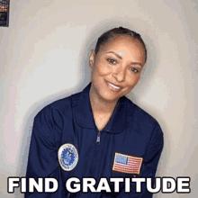 a woman wearing a blue jacket with an american flag on it is smiling with the words find gratitude below her