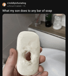 a person is holding a bar of soap that looks like a donut