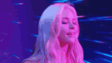 a woman with blonde hair is looking at the camera in a pixel art style .