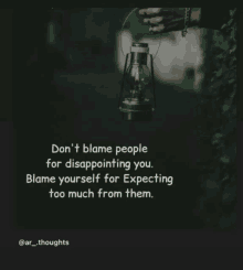 a person holding a lantern with a quote that says " don t blame people for disappointing you "