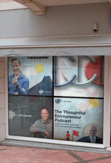 the thoughtful entrepreneur podcast is advertised on the window of this building