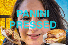 a woman holding a plate of panini pressed food