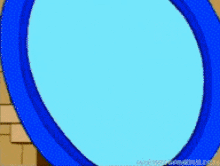 a cartoon drawing of a blue circle with a brick wall behind it