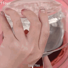 a close up of a person 's hand reaching into a glass container with the words flour written on the bottom