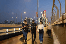 a group of police officers walking on a bridge