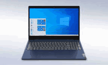 a laptop computer is sitting on a table with a blue screen .