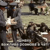 a group of chimpanzees are sitting at a table with plates of food being served by a man in a suit .