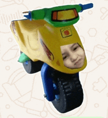 a yellow and green toy scooter with a child 's face cut out of it