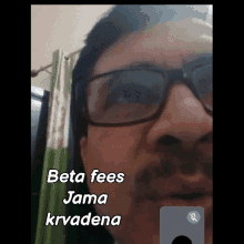 a man wearing glasses and a mustache says beta fees jama krvadena on a video call