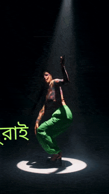 a poster for kuhelikan starmaker shows a woman squatting down on a stage