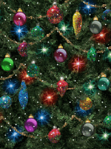 a christmas tree is decorated with lots of colorful ornaments