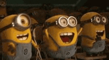 a group of minions are standing next to each other with their mouths open .