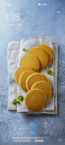 a phone screen shows a stack of cookies on a napkin and the time is 3:35